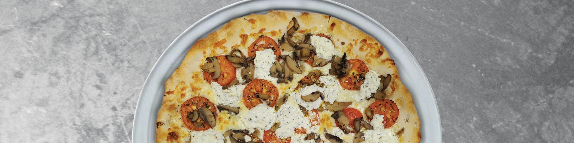 A delicious specialty pizza with feta cheese mushrooms and tomatoes